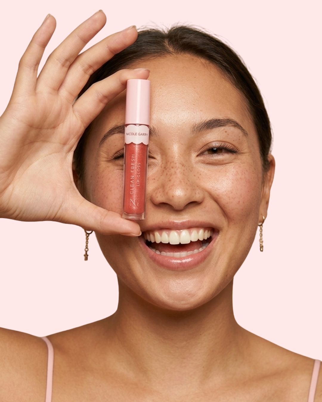 Model holding Nicole Garry Clean Fresh Lip Gloss